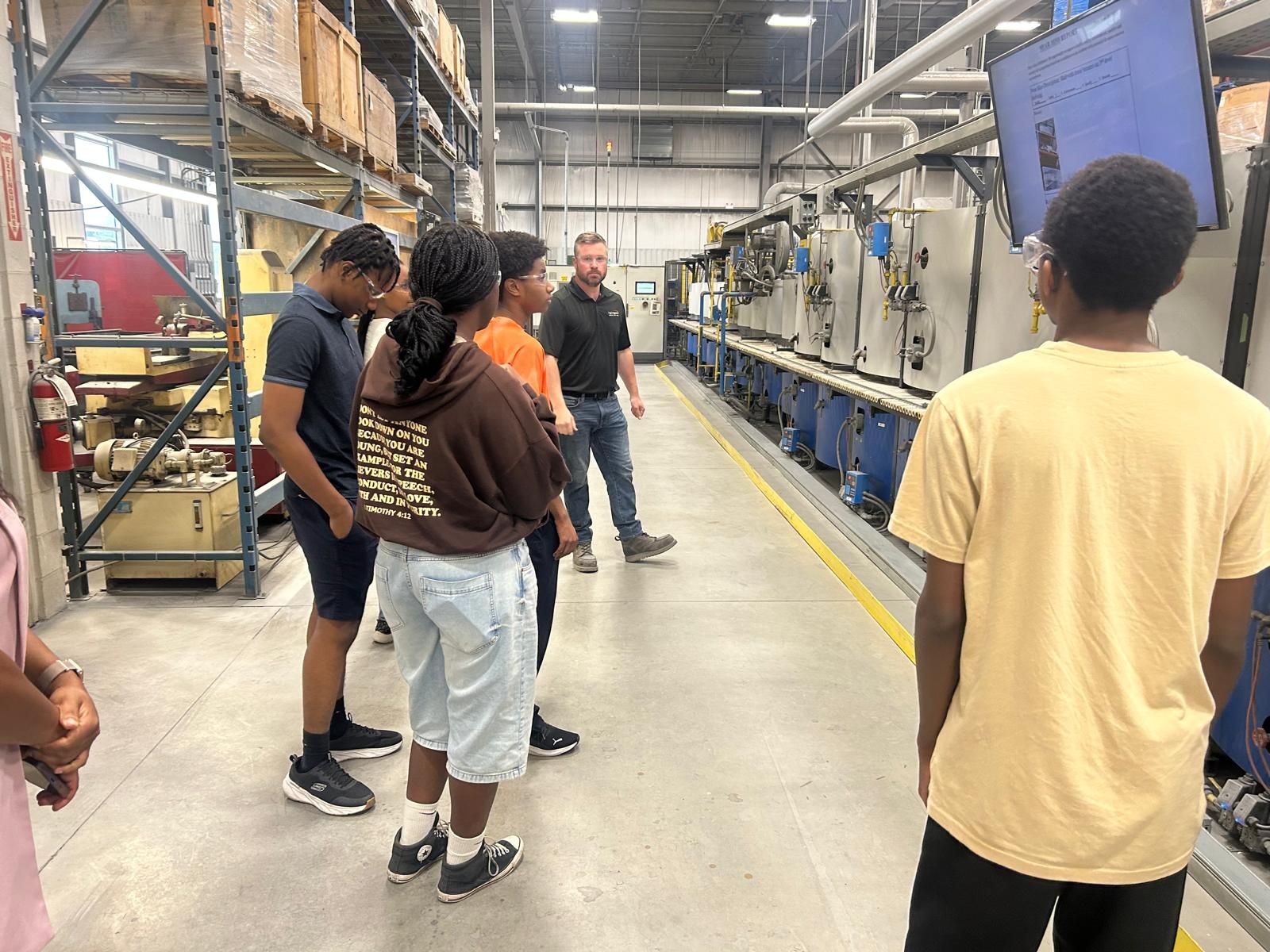 Black Youth in Business students tour a manufacturing facility.